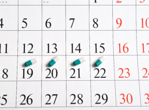 close-up of green capsules with pills is in the calendar